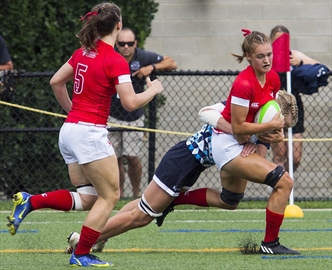 Ontario’s Jordan Smith, with the ball, is taken down by Nova Scotia in Canada Summer Games women’s rugby sevens Monday at Brock University in St. Catharines.