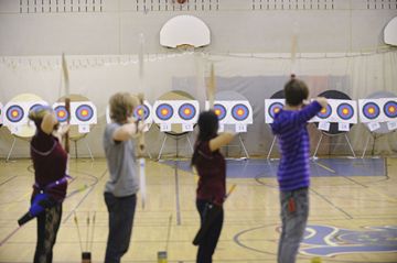 Competitors line up their shots during the city-wide high school archery championship at Riverdale Collegiate April 25.