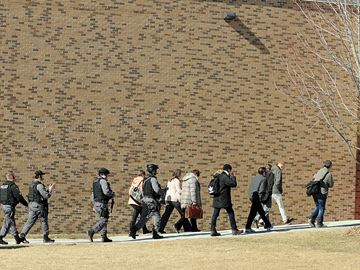 PICKERING -- Six students and two staff members were injured by a knife-wielding female student at Dunbarton High School in Pickering. Durham police tactical support team members led staff back into the main school building. February 23, 2016.