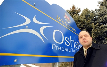 Former Oshawa Councillor Robert Lutczyk, pictured in front of Oshawa welcome sign in 2009, is vying for his old spot on council from a jail cell where he awaits trial on accusations he kidnapped the city's solicitor at gun point.