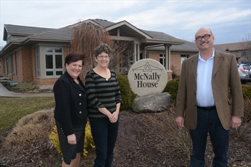 McNally House executive director Pamela Blackwood, medical director Dr. Denise Marshall and board member Murray Bain stand in front of the hospice, which marks its 10th anniversary this week.