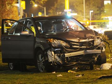 Toronto police investigate after three teens were hit by a vehicle and rushed to hospital on Lawrence Avenue just west of Don Mills Road Monday, Oct. 31. The silver vehicle ended up on the grass of an apartment building after a three-vehicle collision. Oct. 31, 2016.