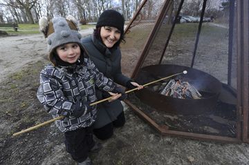 Felix and his mom Genevieve roast a marshmellow during the festivities at Colborne Lodge. (Jan. 20, 2013)