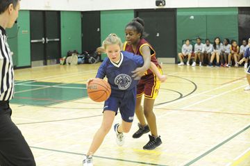 The Toronto Catholic District School Board held its Divisional Basketball Tournament on Friday at Don Bosco Catholic School. In this game a player from Our Lady of Peace (blue) wheels her way around a St. Dorothy's player on her way to the basket. St. Dorothy's won the game by a score of 35 to 12. (Feb. 22, 2013)