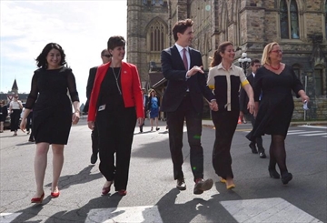 Status of Women Minister Maryam Monsef, left to right, Minister of International Development and La Francophonie Marie-Claude Bibeau, Prime Minister Justin Trudeau, Sophie Gregoire Trudeau and Women Deliver President and CEO Katja Iversen arrive at an event in Ottawa on Tuesday, June 13, 2017. The Liberal government is thinking about using its massive purchasing power to support women in business. THE CANADIAN PRESS/Sean Kilpatrick