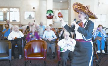 Marie Gogo, right, entertains at Scarborough's Retirement Suites by the Lake during a party to celebrate Cinco de Mayo.