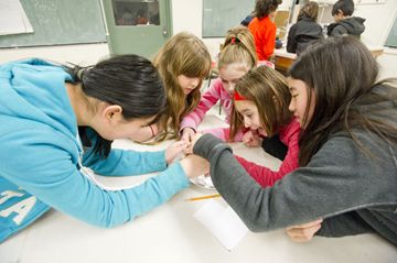 Jenny Zhang, left, Maryalice Gaetano, Sonja Ross, Melanie Hawie, and Alexandra Li work on solving the mystery of the missing cookies in the crime scene investigation workshop during the Jr DEEP March break program at the University of Toronto Monday afternoon.
