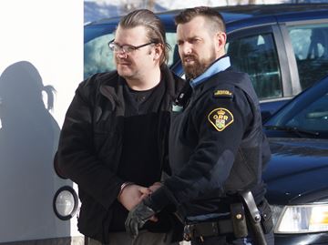 James Sarsfield of Barrie is led by police into a Muskoka courthouse on Feb. 22 where he pleaded guilty to four different sex crimes against children.