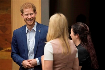 Prince Harry talks with Bronwen Evans and Leah Cuffe, right, during a reception before the True Patriot Love Symposium, in Toronto on Friday, September 22, 2017. THE CANADIAN PRESS/Chris Young