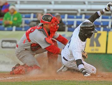 Majors DH Parris Austin slides in under Cardinals catcher Zack Sardellitti to score London's second run in the third inning.