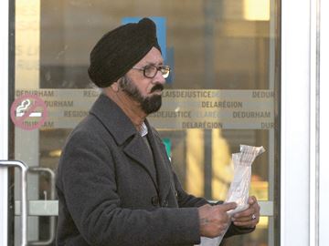OSHAWA -- Mohinder Singh Saini left the Oshawa courthouse after being released on bail on November 9. The Quebec trucker is charged with four counts of dangerous driving causing death and 11 counts of dangerous driving causing bodily harm relating to a 21-vehicle pile-up on Hwy. 401 in Whitby on October 2. November 9, 2015