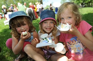 Sisters Amy, Julia and Charlotte enjoy birthday cake in the town square.