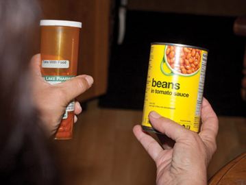 Left hand: prescription container - Right hand: Beans in tomato sauce