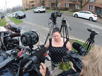OSHAWA -- Neighbour and family friend Judy Wolecki spoke to the media in front of a townhouse complex on Colborne Street which was the scene of a shooting the night before. A seven-year-old boy was shot Thursday night but police say he was not the intended target. Police say the boy was hit by a stray bullet while he was inside a residence at Gateway Terrace on Colborne Street West near Centre Street around 10:30 p.m., while a man in his 20s was shot outside a townhouse. April 22, 2016.