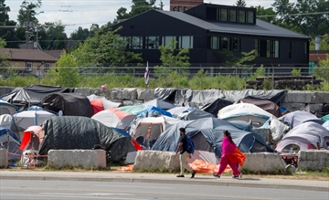  Tents crowd in a lot at Weber and Victoria Streets in Kitchener on Tuesday.