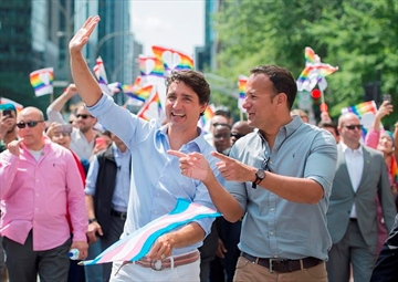 Prime Minister Justin Trudeau, left, talks with Irish Taoiseach Leo Varadkar during the annual pride parade in Montreal, Sunday, August 20, 2017. THE CANADIAN PRESS/Graham Hughes