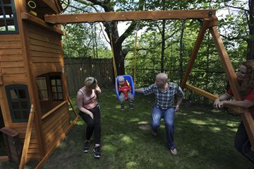 Gabriel Benun, who is in remission from Infant Acute Lymphoblastic Leukemia, has a swing with his mom Nikki Russell-Benun and dad Asaph on their new playground built by Million Dollar Smiles Thursday.