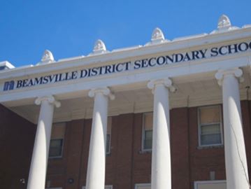 The main columns of the highschool have classic Beaux-Arts features.