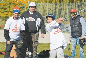 Batter Thomas Hodder takes a swing with catcher Anthony Finelli and umpire Thomas Hodder (Sr.) at the plate during Canadian Tire Jumpstart activities at Rexlington Park on Saturday. (Oct. 17, 2015)