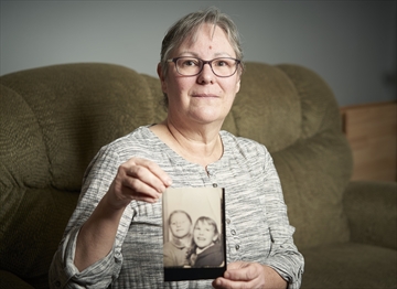 Susanna Marie Kuhn is searching for two siblings adopted from Guelph in the late 1960's. She's seen here, holding a photo of her sister Paula.