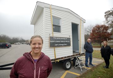 Meghan Sheffield, a steering committee member of the Northumberland Sleeping Cabin Collective, is seen here at the Northumberland YMCA in Cobourg, as a sample sleeping cabin makes it way around the Cobourg-Port Hope area.