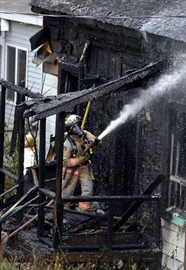 Firefighters at the house fire Wednesday on Emerald Street North near Birge.