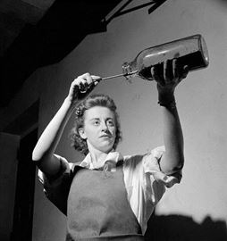 Worker poses emptying a bottle containing penicillin mould during penicillin production at the Connaught Labs in Toronto in May 1944.