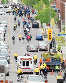 Off in the dsitance Hundreds of cyclists tooking part in the Bells on Bloor ride on Saturday leading off along Bloor Street from High Park to downtown Toronto. May 11