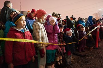 Children wait at the front of the line for the CP Holiday Train to pull into Lambton Yard on Saturday. The evening included food and cash donations and entertainment on the boxcar. The train is raising awareness about hunger issues in Canada while visiting over 150 communities. (Dec. 1, 2012)