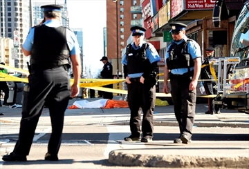 Police secure an area around a covered body in Toronto after a van mounted a sidewalk crashing into a number of pedestrians on Monday, April 23, 2018. THE CANADIAN PRESS/Nathan Denette