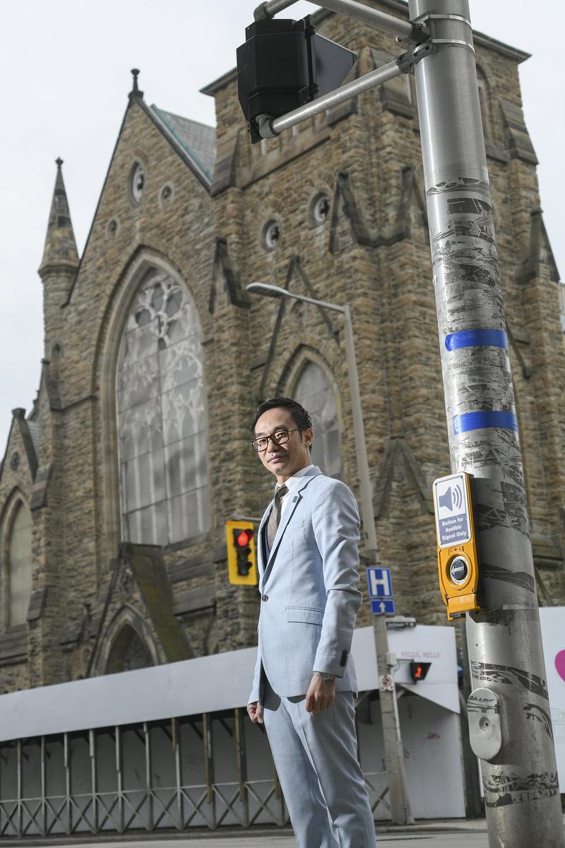 Allen Le Nam standing in front of the former James Street Baptist Church