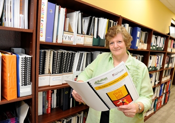 Heather Thompson, manager of age friendly initiatives with Community Development Halton, with a copy of the Halton HomeShare toolkit.