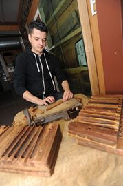 Kris Miller works on a cigar at the Frank Correnti Cigar factory.