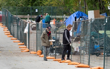 Fences have been placed around a homeless encampment in Cambridge.