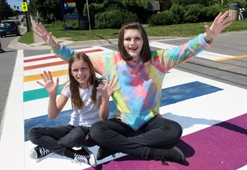 Transgender youth Hailey Canning (right) and younger sister Alexis show their excitement for the new rainbow crosswalk in Acton.