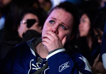 A Maple Leaf fan breaks down in tears after watching her team lose a 5-4 overtime heartbreaker to the Boston Bruins Monday, May 13. The Leaf faithful gathered in Maple Leaf Square outside the Air Canada Centre to catch the Game 7 television broadcast from Boston on a giant video screen.